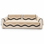 Scalloped chenille sofa cover in black coffee with contrast trim on a white studio background